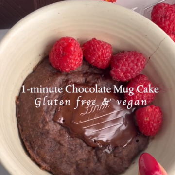 chocolate mug cake in a bowl with raspberries and dark chocolate