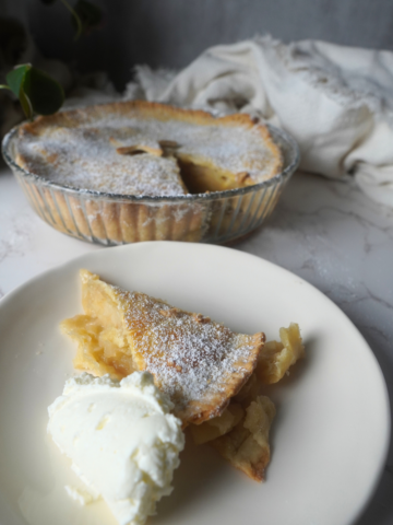 apple pie on a plate with whipped cream