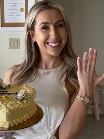 weight loss dietitian holding a cake saying "engaged" and showing engagement ring