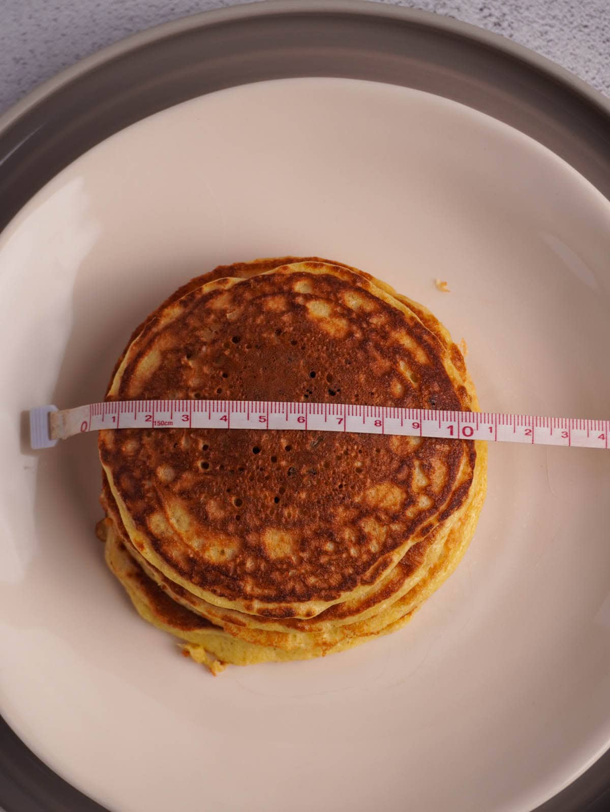 A protein pancake on a plate showing that it is 10cm long. 